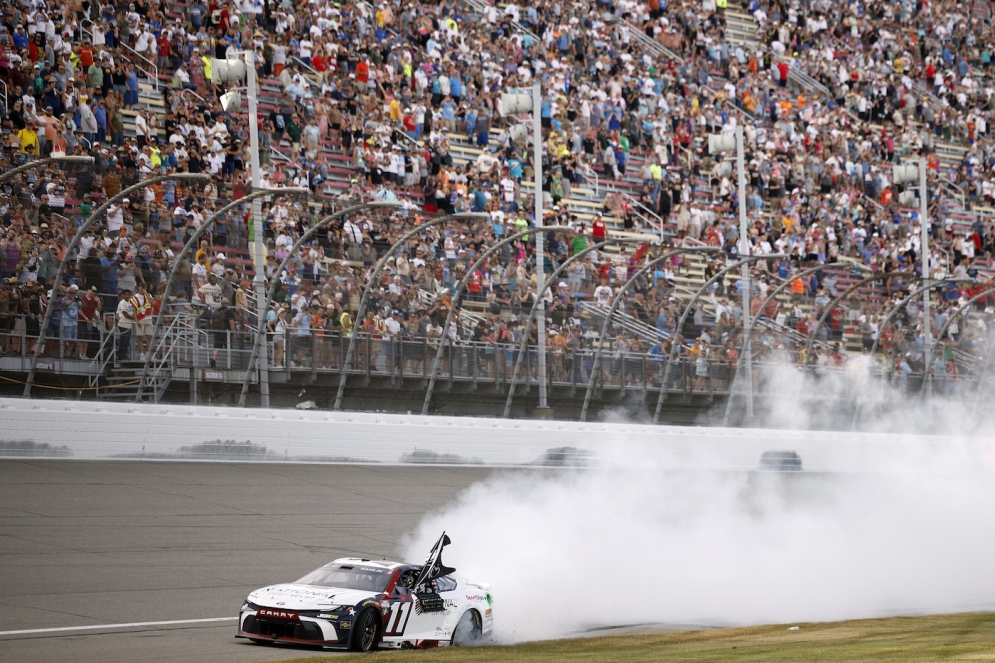 Denny Hamlin celebrates with a burnout after winning the NASCAR Cup Series race at Michigan International Speedway on June 7, 2026, in Brooklyn, Michigan.